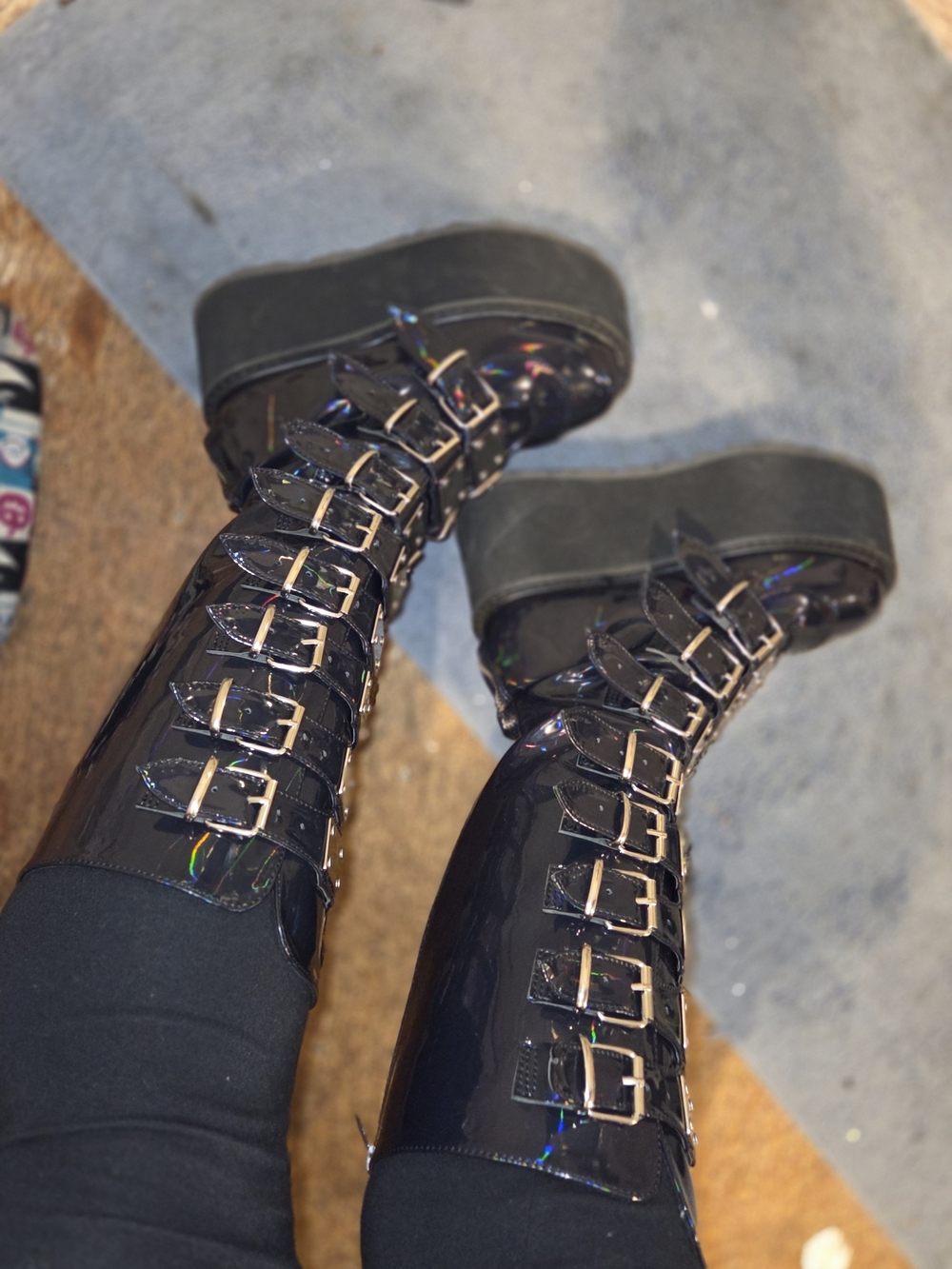 DEMONIA Platform Buckle Knee-High Buckle Boots in Black
